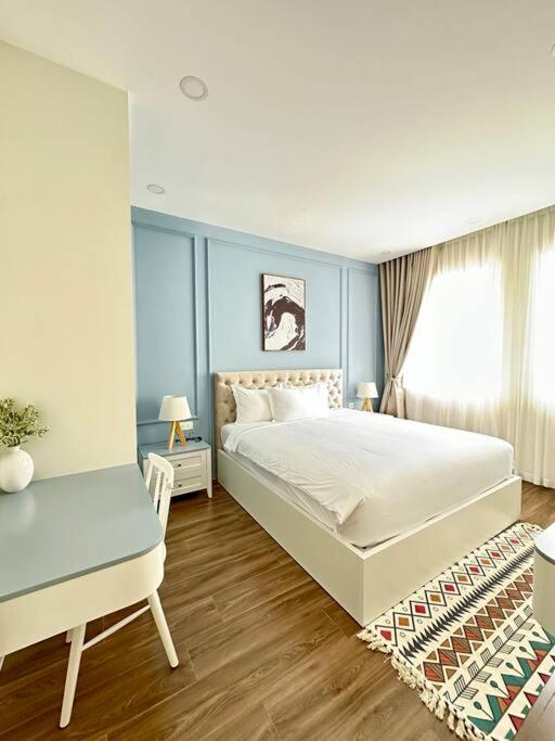 a bedroom with a white bed and a window at Novaworld Phan thiết - Alina house- 2 bed rooms in Bình Sum