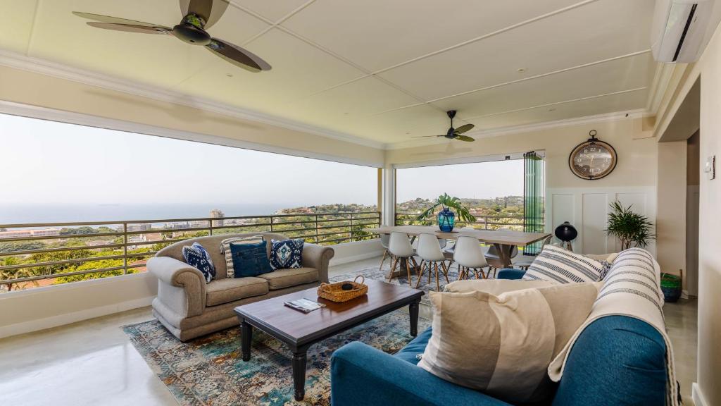 a living room with a view of the ocean at 17 Malibu, Beverly Hills Estate in Ballito