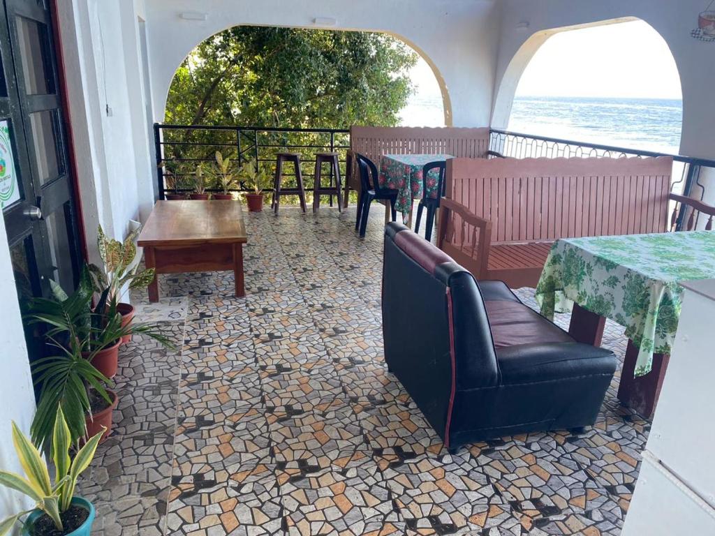 a patio with a table and chairs and a table and a table and chairsktop at SEASCAPE in Moalboal