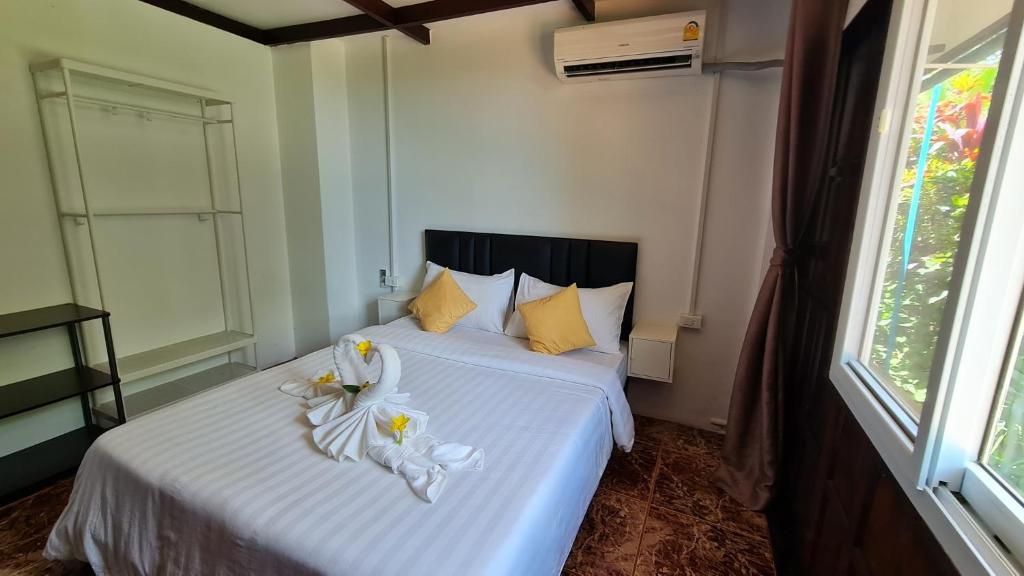 a bedroom with two beds with towels on them at Koh Mak Garden View in Ko Mak