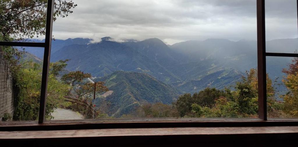 a view of a mountain range from a window at Shiyai Taoyuan in Ren'ai