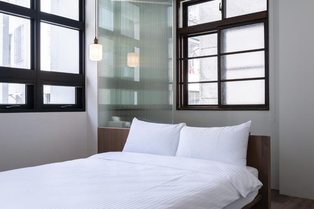 Postel nebo postele na pokoji v ubytování Yu Tainan BnB