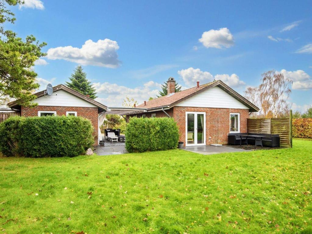 a brick house with a lawn in front of it at Holiday home Sydals XCIV in Skovmose