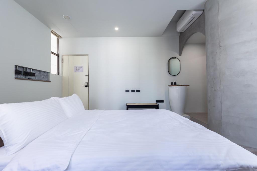 Postel nebo postele na pokoji v ubytování Yu Tainan BnB