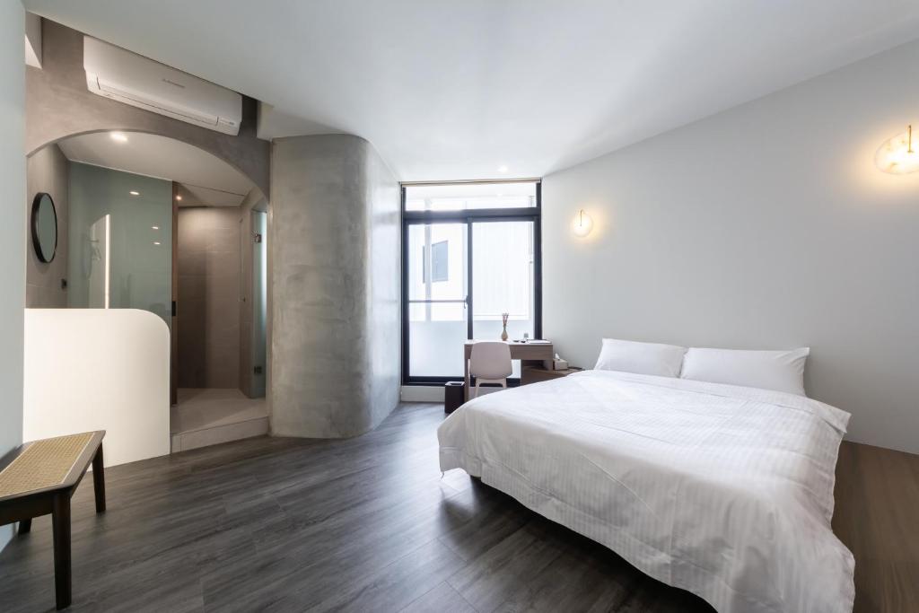 Postel nebo postele na pokoji v ubytování Yu Tainan BnB