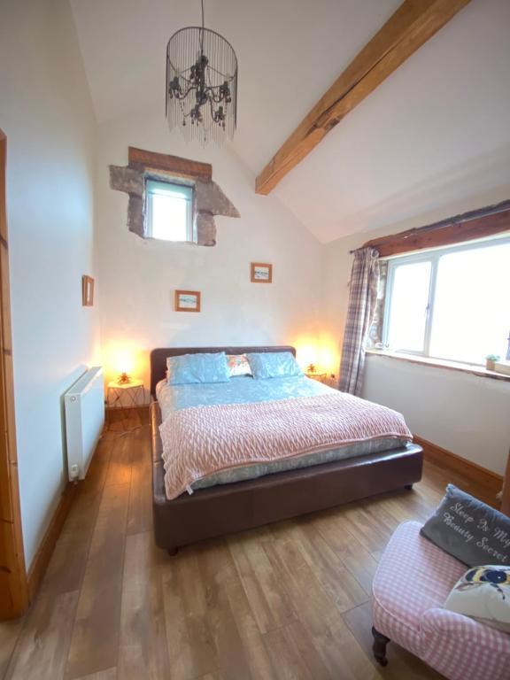 a bedroom with a bed and a window at Unique Stay on an Alpaca Therapy Farm with Miniature Donkeys North Wales in Mold