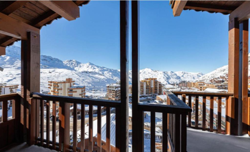 a balcony with a view of snow covered mountains at Exclusive Chalet Val Thorens Center by GlobalSki in Val Thorens