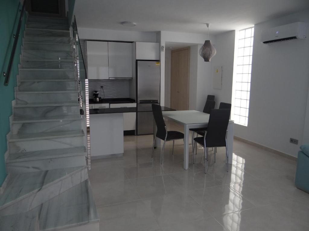 una cucina e una sala da pranzo con tavolo e sedie di Villa Sinergia 3 bedrooms a Los Alcázares