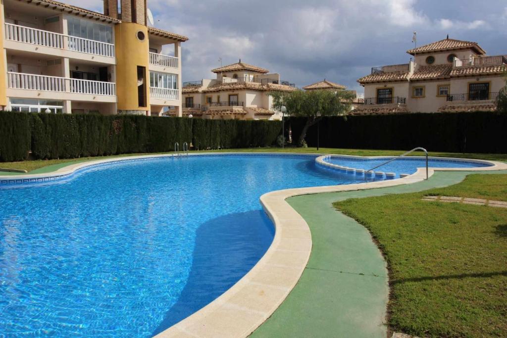 duży basen przed budynkiem w obiekcie Relax Family home Zenia bulevard w mieście Orihuela