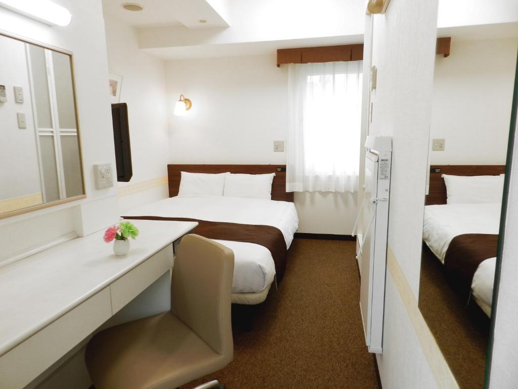 Postel nebo postele na pokoji v ubytování Hotel Check In Shimbashi