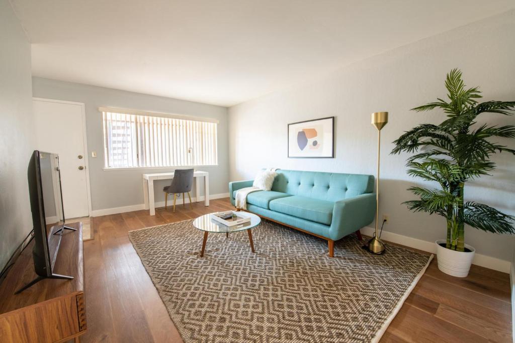 a living room with a blue couch and a rug at Santa Clara 2br w wd nr caltrain station SFO-1524 in Santa Clara