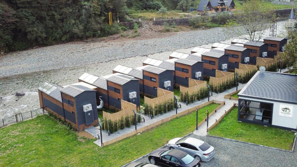 an aerial view of a row of houses with cars parked at River Side TinyHouse in Çamlıhemşin