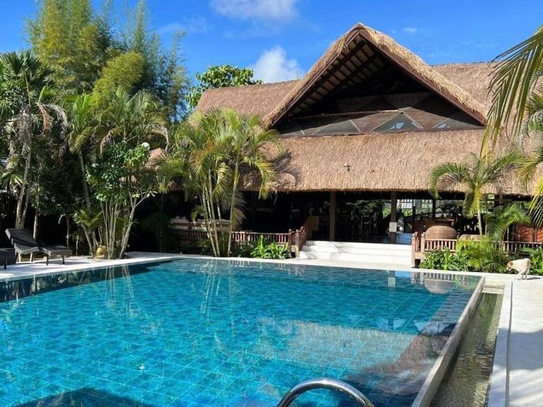 a swimming pool in front of a resort at Lio Villas Resort in El Nido