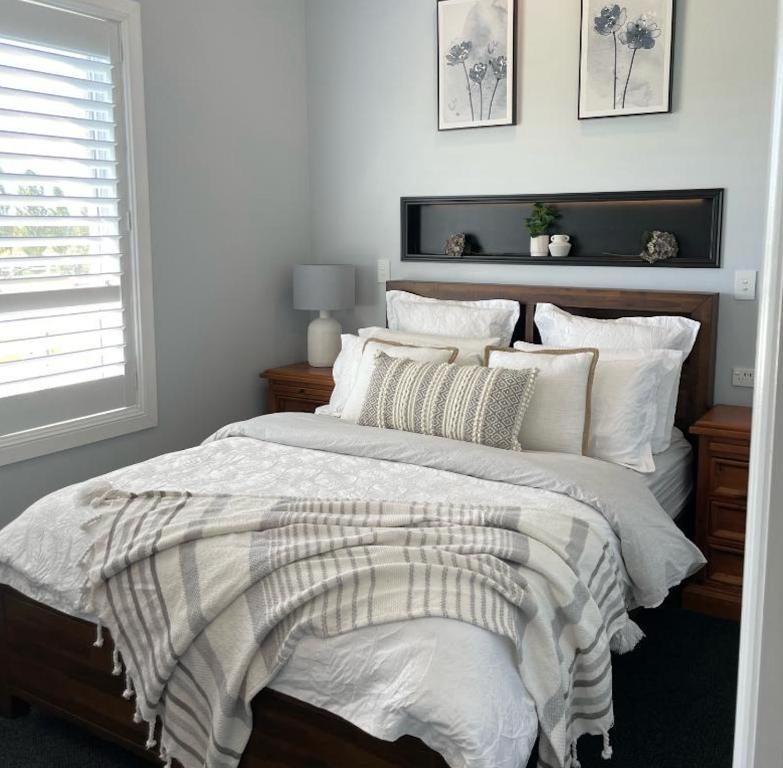a bedroom with a large bed with white sheets and pillows at The Shaddy Rest secluded resort for the perfect romantic getaway in Orange