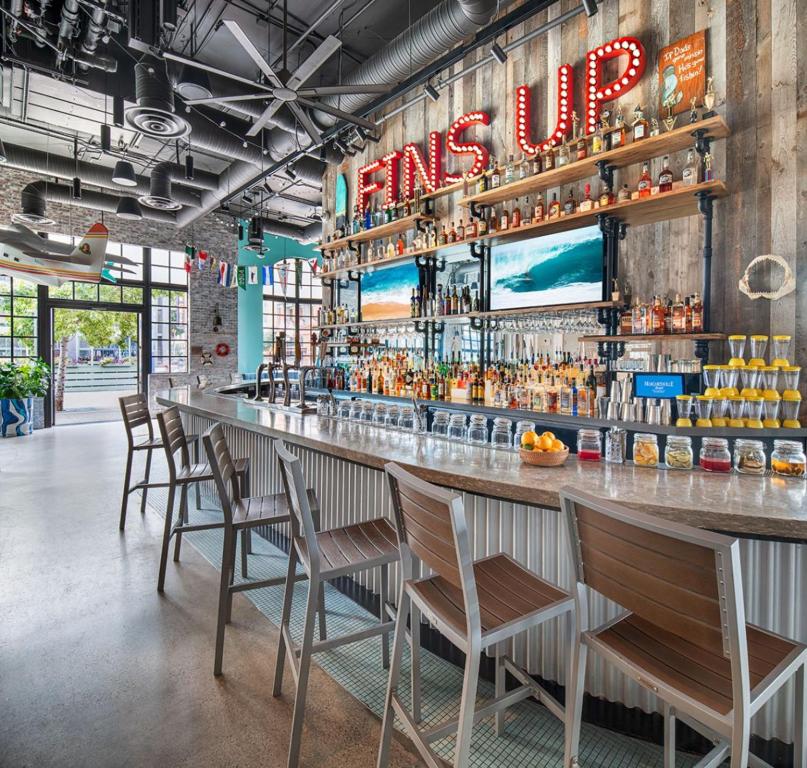 a bar in a restaurant with chairs around it at Margaritaville Hotel San Diego Gaslamp Quarter in San Diego