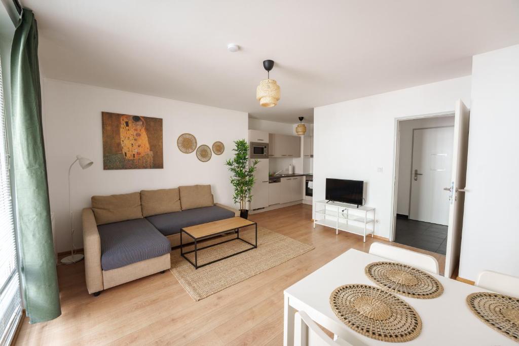 a living room with a couch and a table at Central Living Apartments - Reumannplatz in Vienna