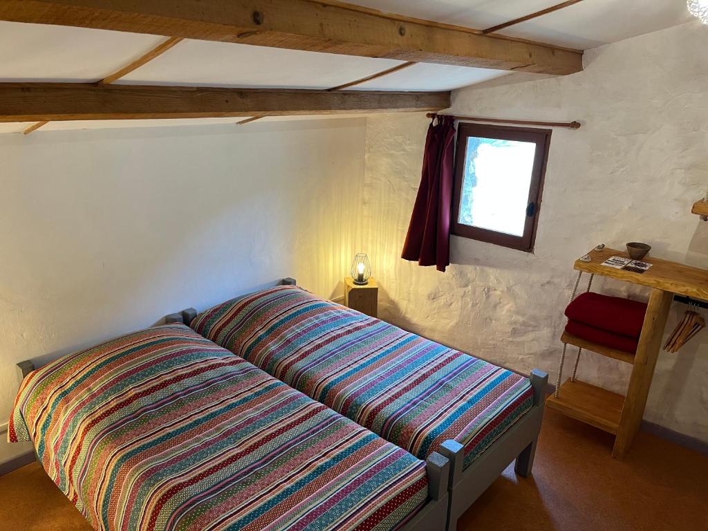 Postel nebo postele na pokoji v ubytování Chambres d'hôtes Gîte Saint Roch