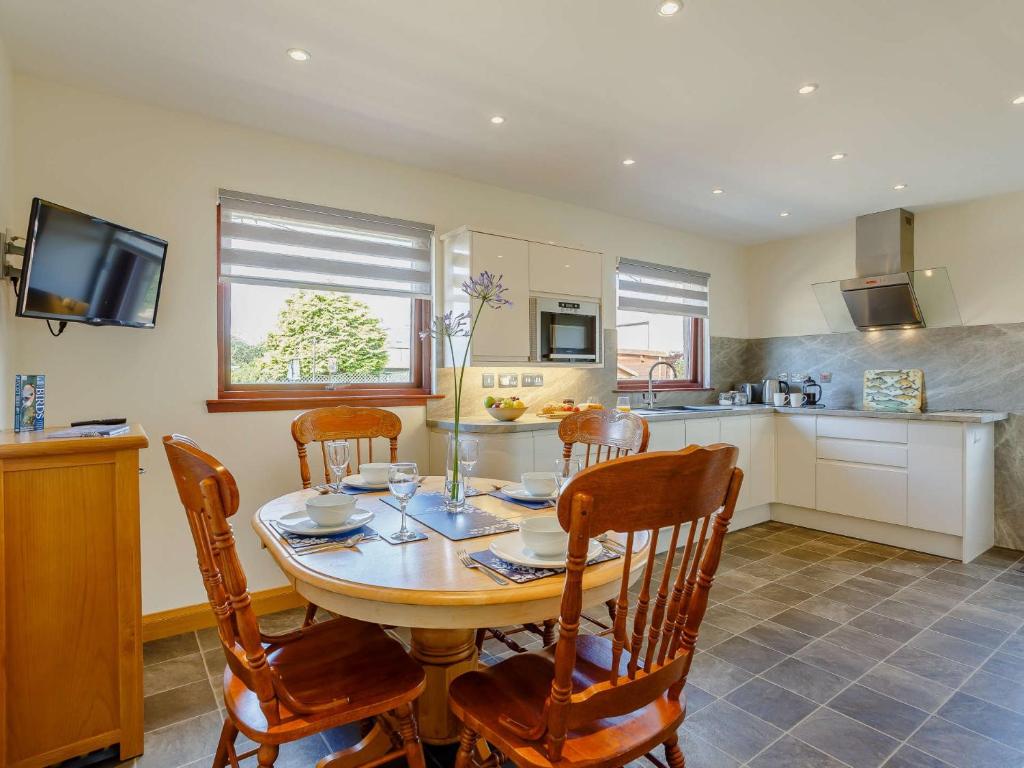 a kitchen with a wooden table and chairs in a kitchen at 2 bed property in Nairn The Highlands 89176 in Nairn