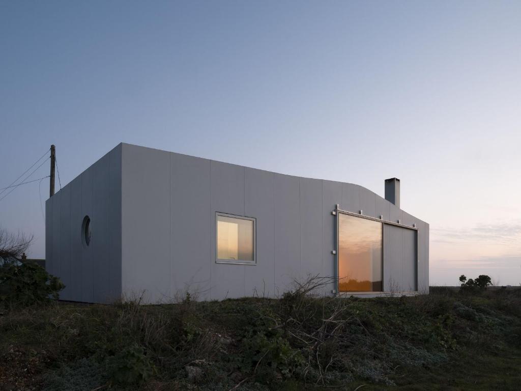 a white house on top of a hill at Channel View, Dungeness by Bloom Stays in Dungeness