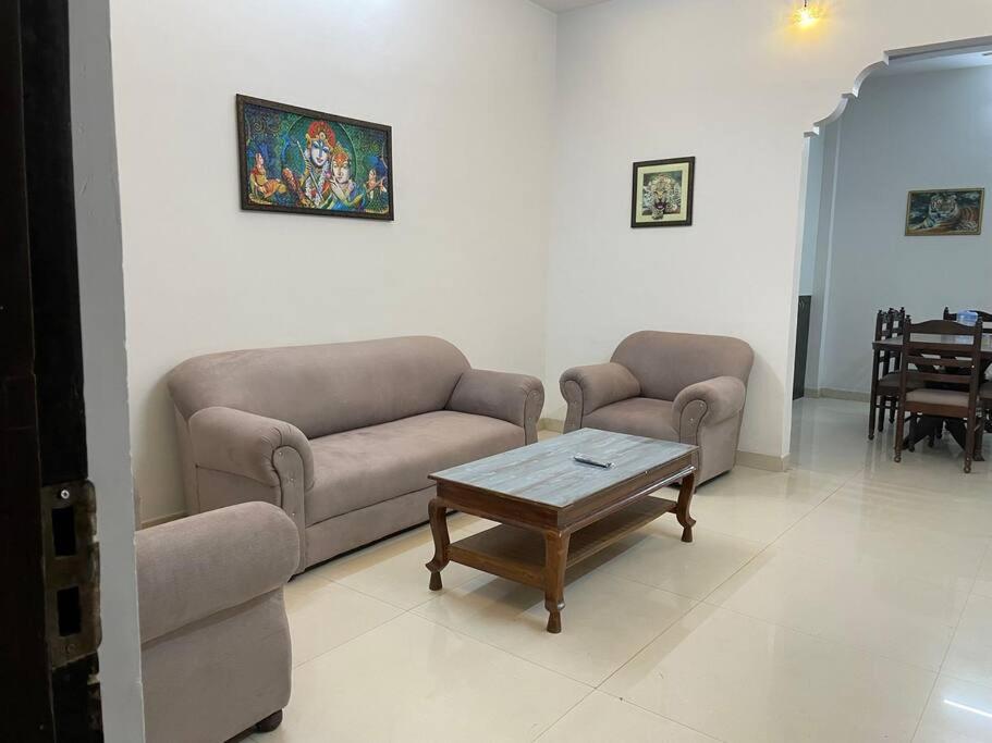 a living room with two couches and a coffee table at Leela home stay - Lotus (2 BHK luxury appartment) in Jabalpur