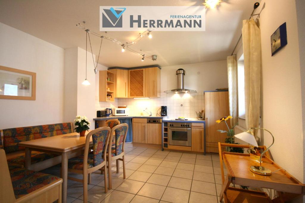 a kitchen with a table and a dining room at Ferienwohnung Romi in Pfronten