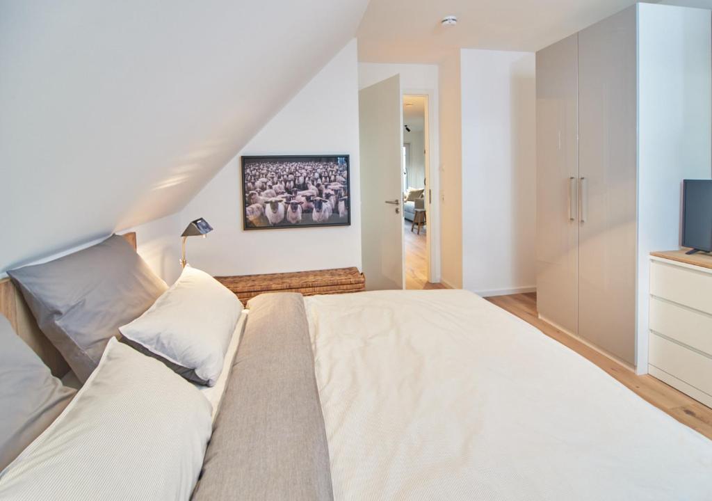 Postel nebo postele na pokoji v ubytování Sunshine Suite - mit Meerblick