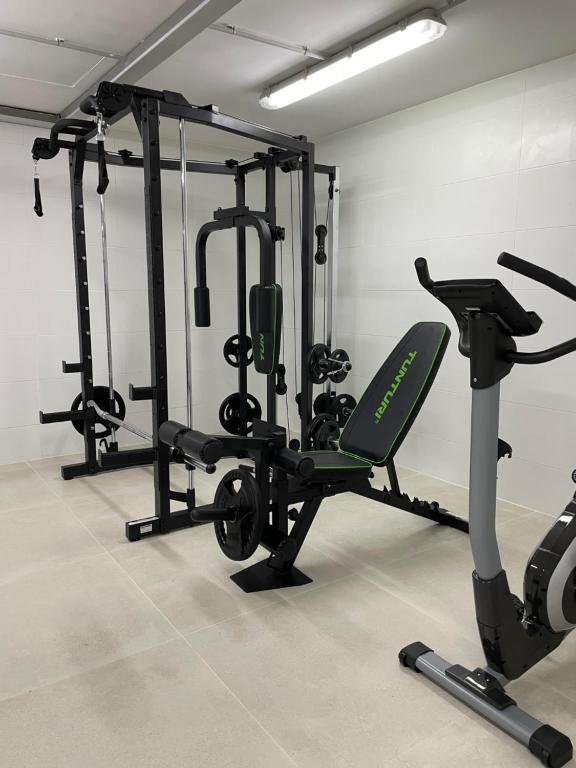 a gym with several tread machines in a room at Apartamentos Playa Victoria in Cádiz