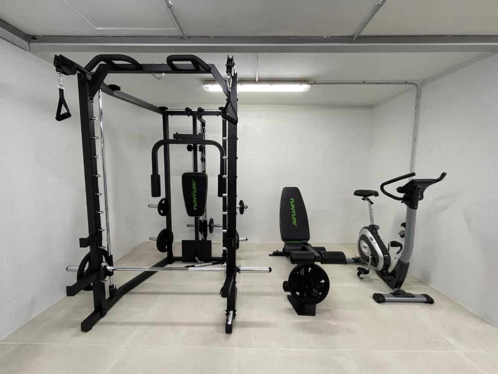 a gym with three exercise bikes in a room at Apartamentos Playa Victoria in Cádiz