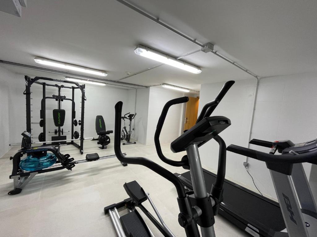 a gym with several exercise bikes in a room at Apartamentos Playa Victoria in Cádiz