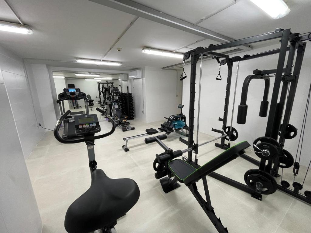 a gym with several tread machines in a room at Apartamentos Playa Victoria in Cádiz