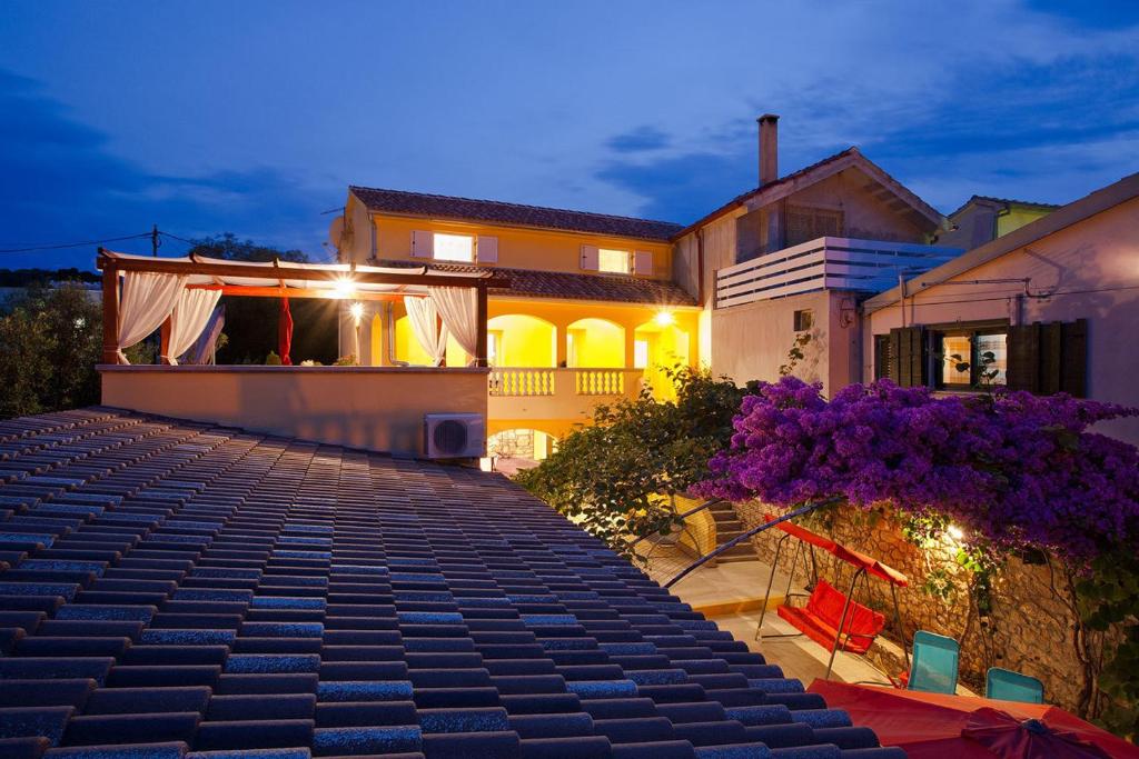 a house with a brick walkway in front of it at Apartments Ferina in Poljana
