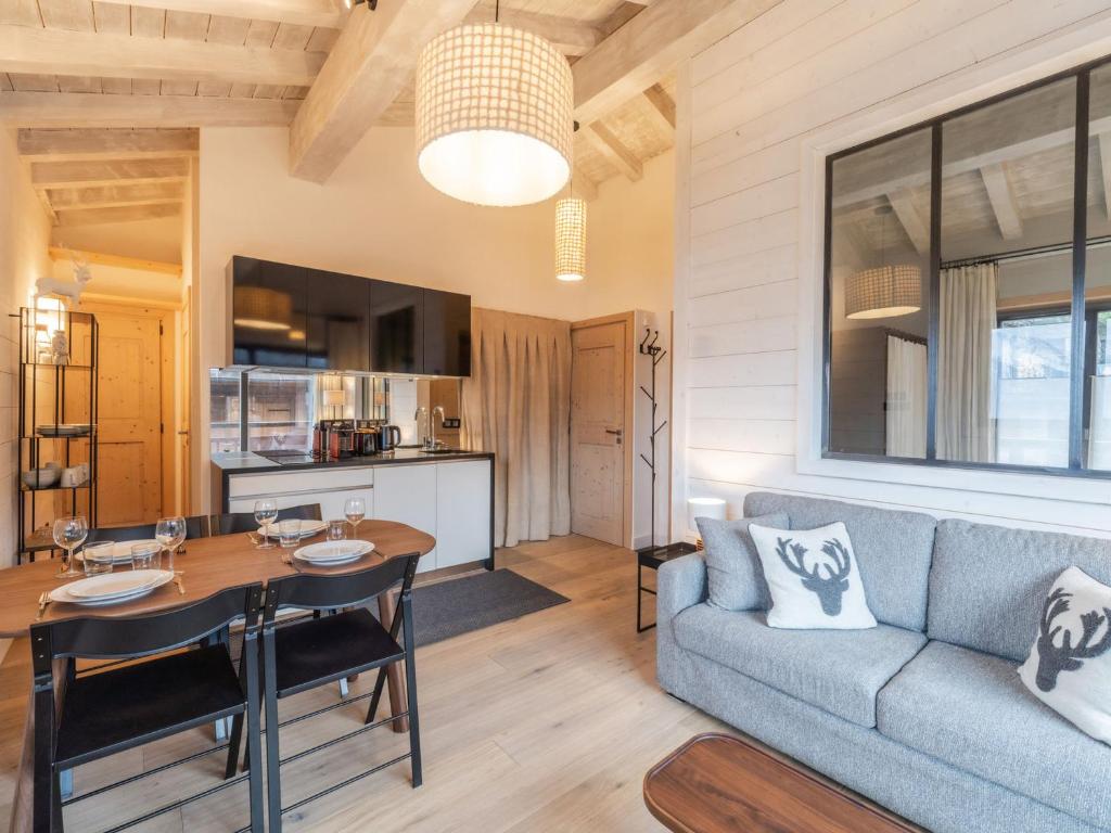 a living room with a couch and a table at Appartement La Tania, 3 pièces, 4 personnes - FR-1-568-23 in Courchevel