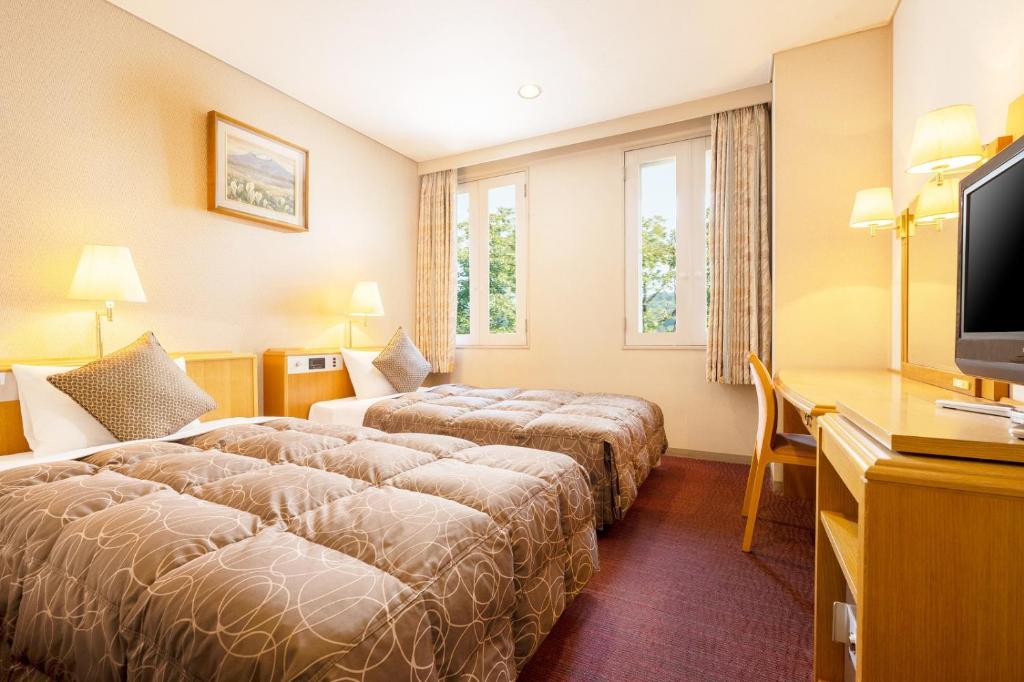Postel nebo postele na pokoji v ubytování KAMENOI HOTEL Fukui