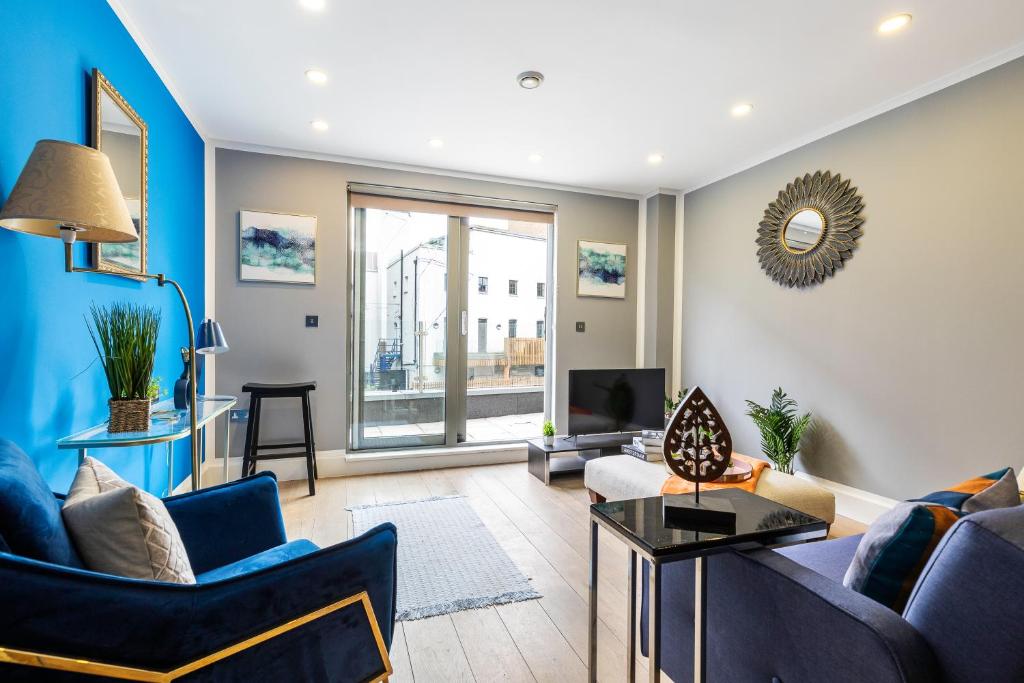 a living room with a couch and a table at Central London Large 3bed 2bath with massive terrace overlooking grand union canal. (8 occupancy) in London