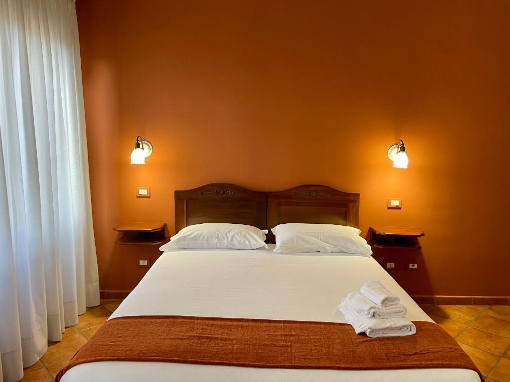 Postel nebo postele na pokoji v ubytování Mingone Hotel Ristorante