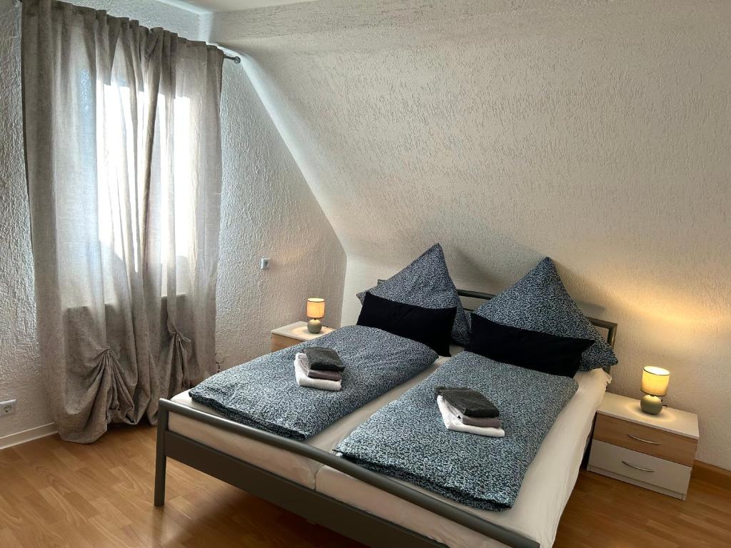 a bedroom with a bed with two towels on it at Wohnung VS 3 in Villingen-Schwenningen
