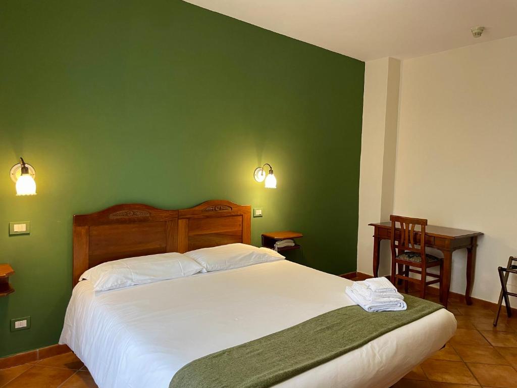Postel nebo postele na pokoji v ubytování Mingone Hotel Ristorante