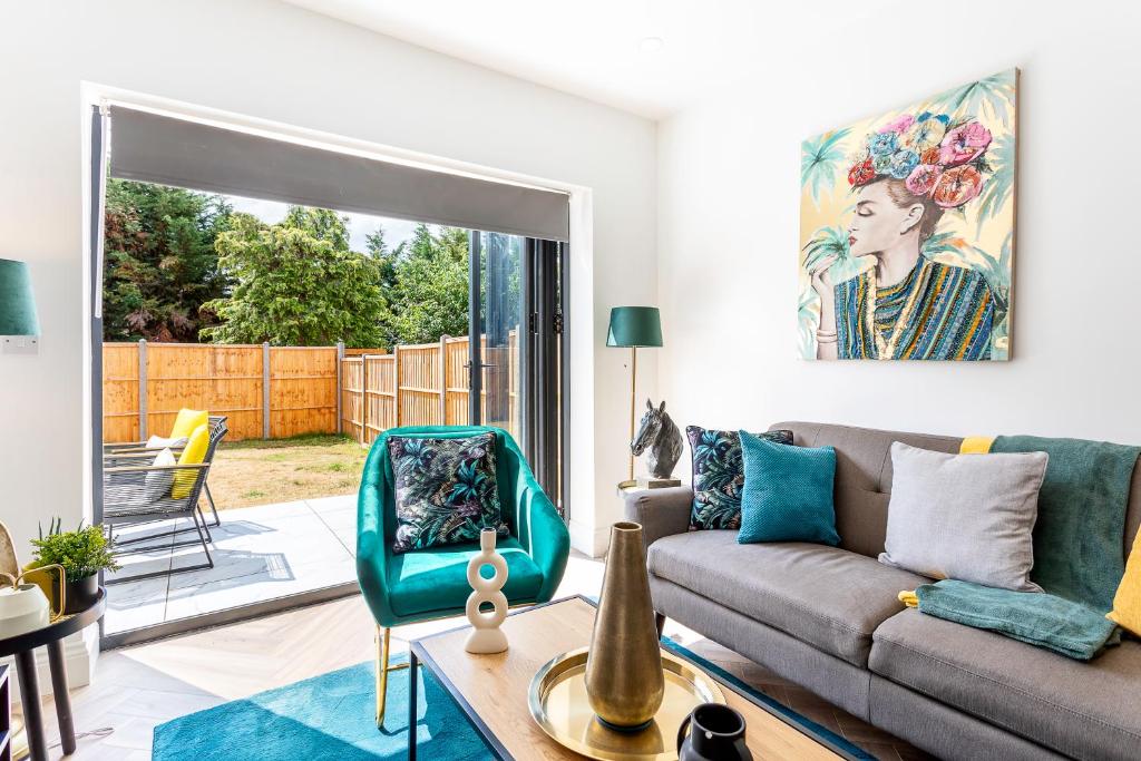 a living room with a couch and a chair at Stunning West London W7 Modern Huge place 4bed 2 bath with garden free parking (7 occupancy) in London