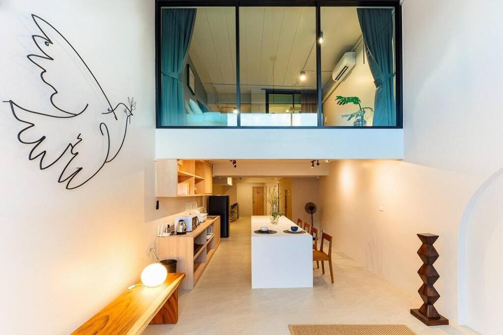 an open living room and dining area of a house at The STYLISH Hometel Sukhumvit in Bangkok