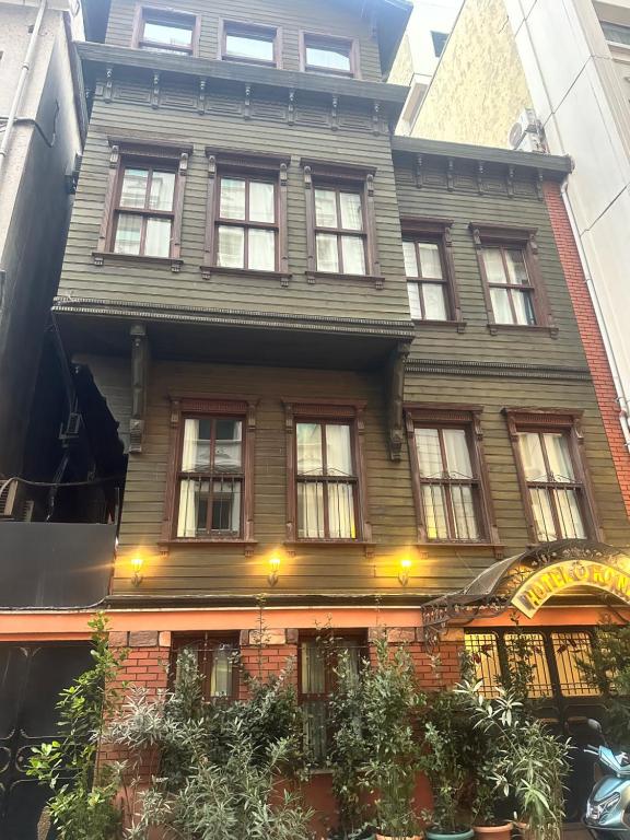 a large wooden house with windows on a city street at Adil Konak Hotel in Istanbul