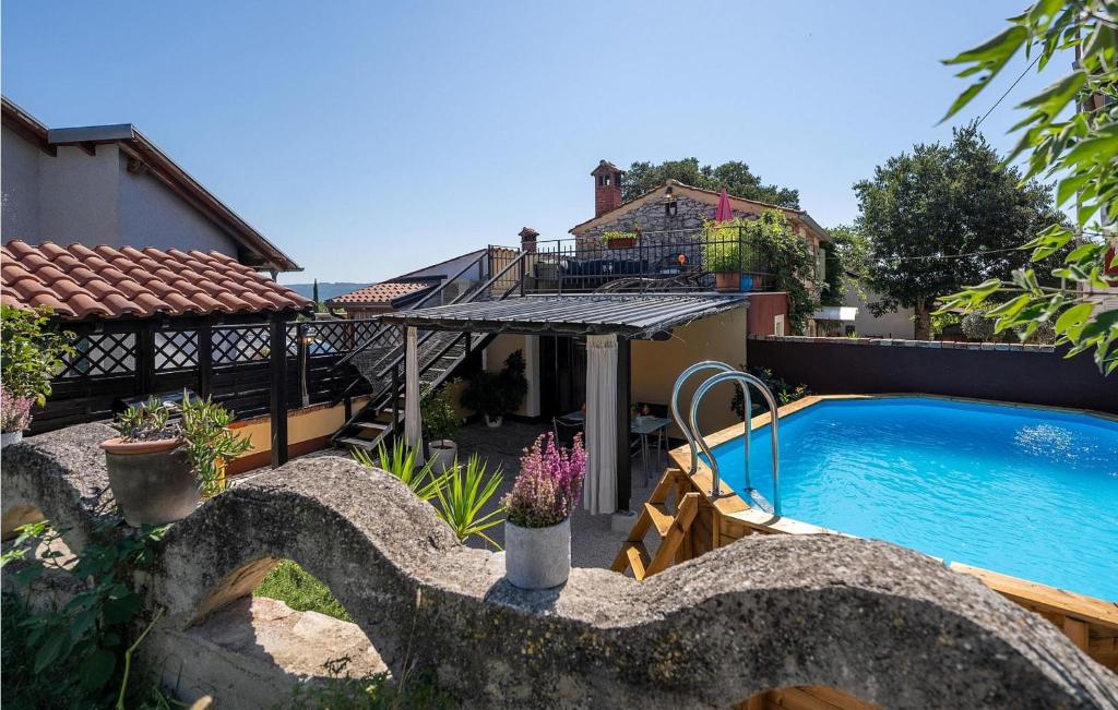 a backyard with a swimming pool and a house at Casa Dvi Mendule in Brtonigla