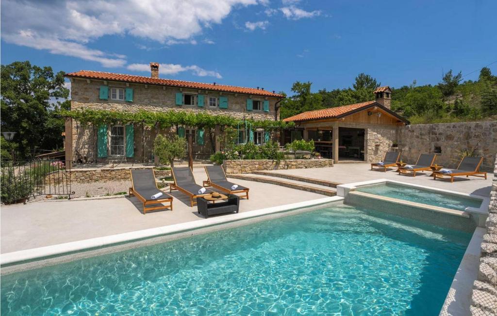 a house with a swimming pool in front of a house at Casa Zamarija in Labin