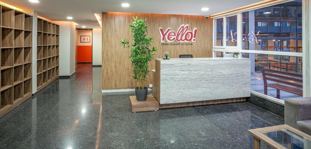 a lobby with a reception desk and a plant at Yello! ITPL in Bangalore