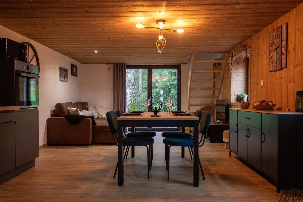 a kitchen and dining room with a table and chairs at Gite de la Ravanne/Le petit nid in Ramonchamp