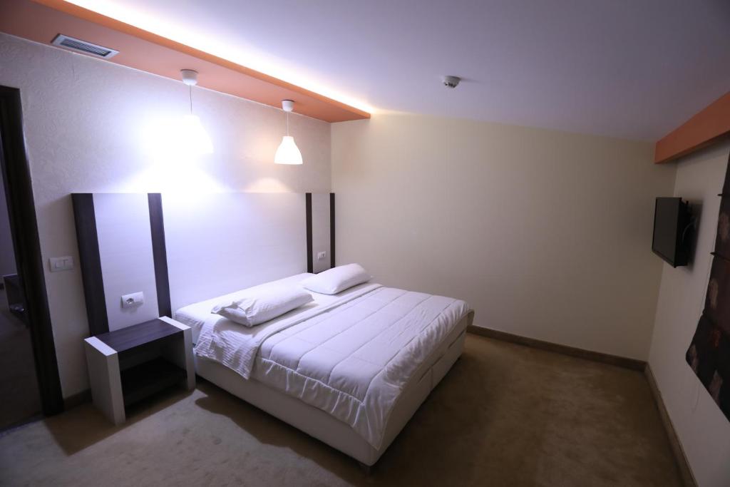 Postel nebo postele na pokoji v ubytování Hotel 1 Maji