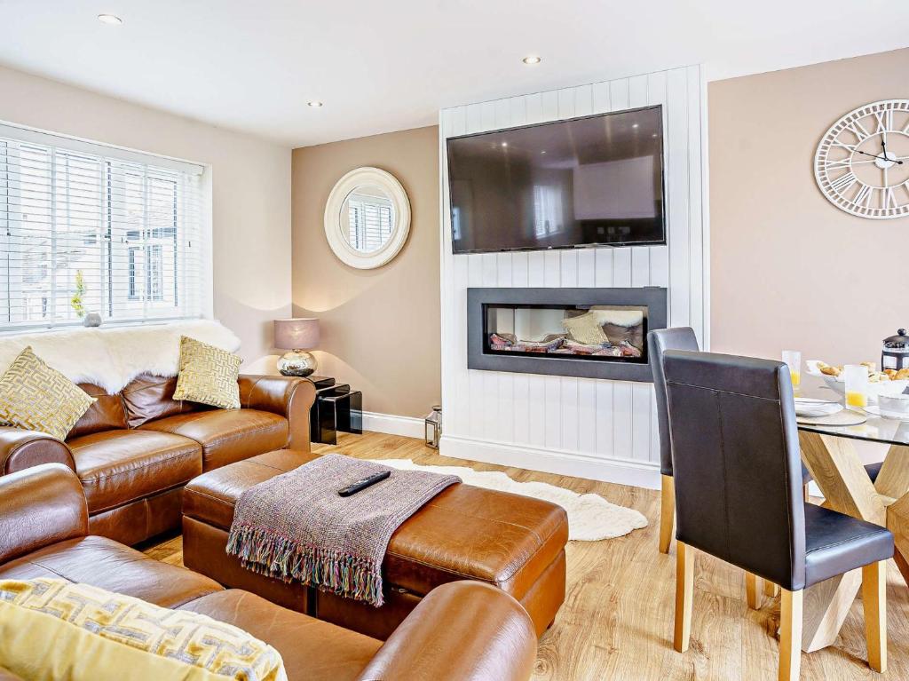 a living room with a couch and a fireplace at 2 bed in Aberaeron 75211 in Mydroilin