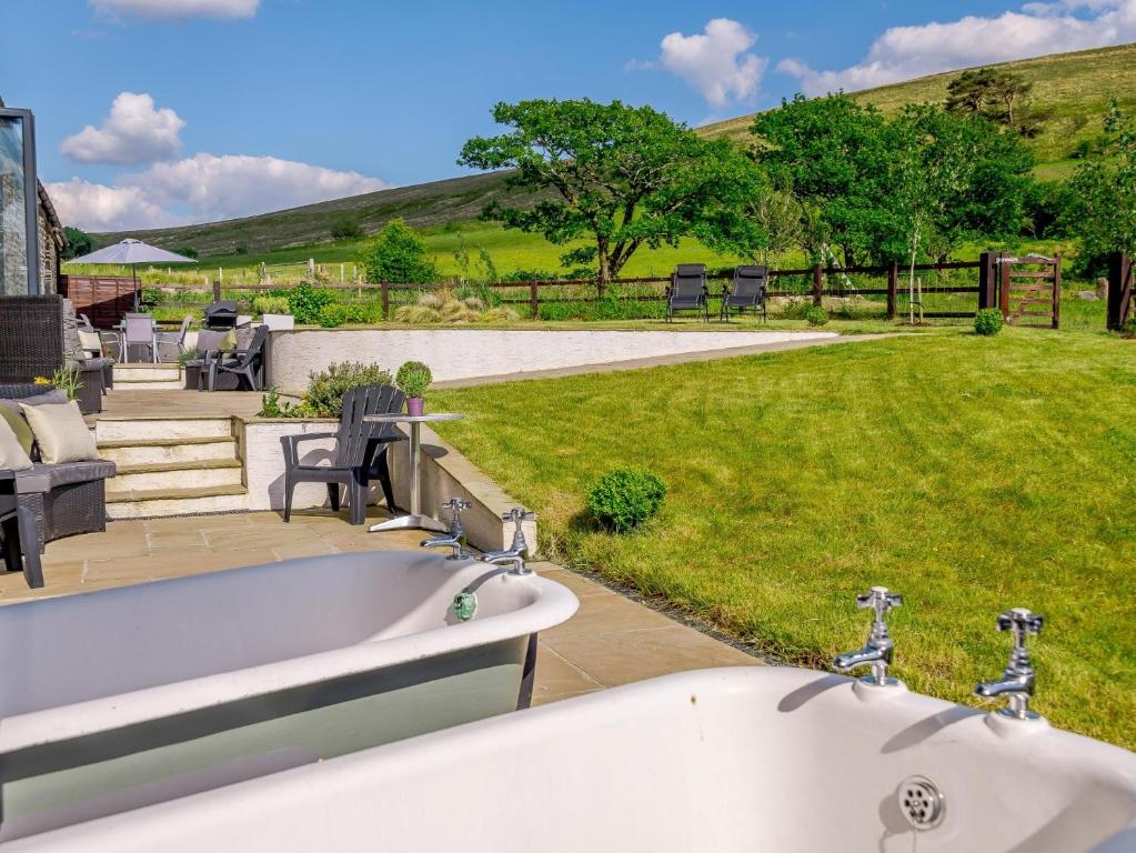 a bath tub sitting in front of a yard at 3 bed in Pontardawe 88346 in Pontardawe