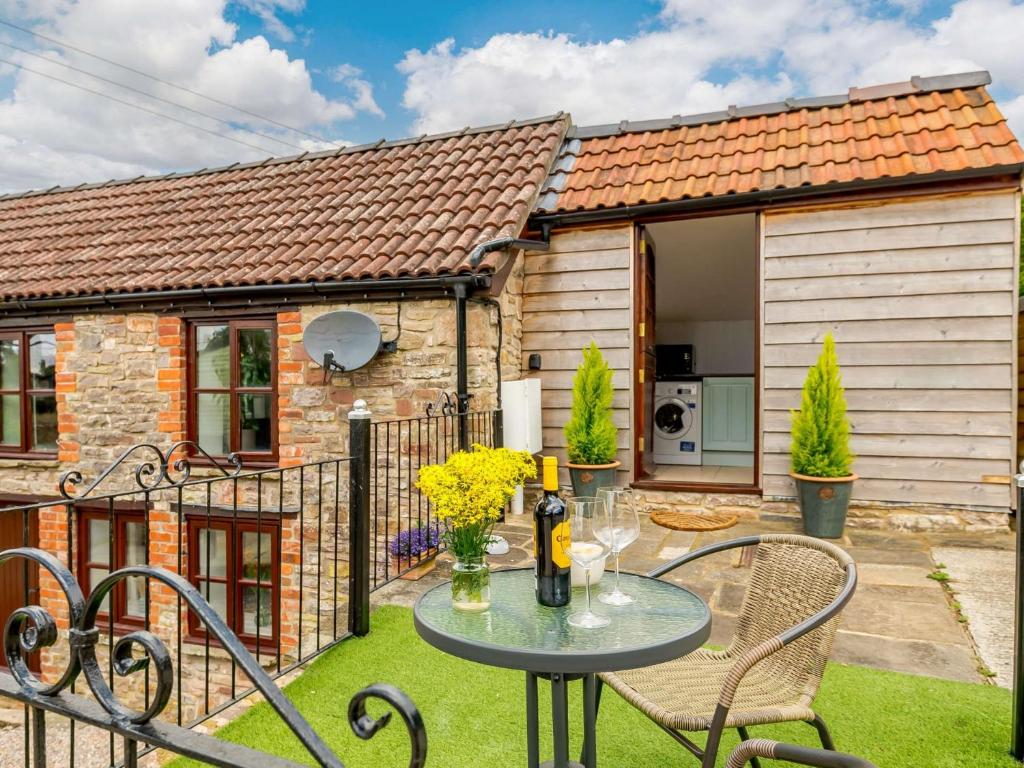 a table and chairs in front of a house at 1 bed in St Briavels 88814 in Saint Briavels