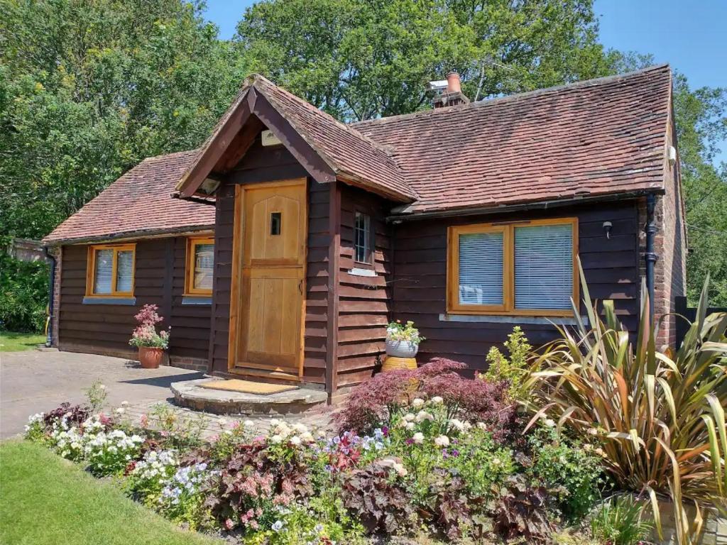 a cabin with a wooden door in a garden at 1 bed in Ashdown Forest 88488 in Nutley