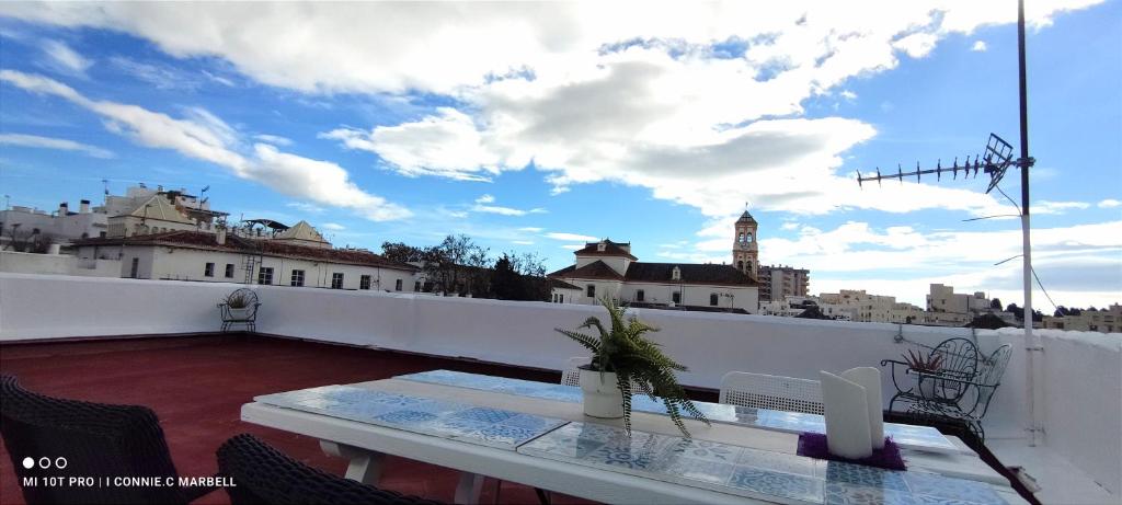 a balcony with a table and a view of a city at Big and cozy apartment with a big terrace in the center of the old town with AC from 2024 summer season in Marbella